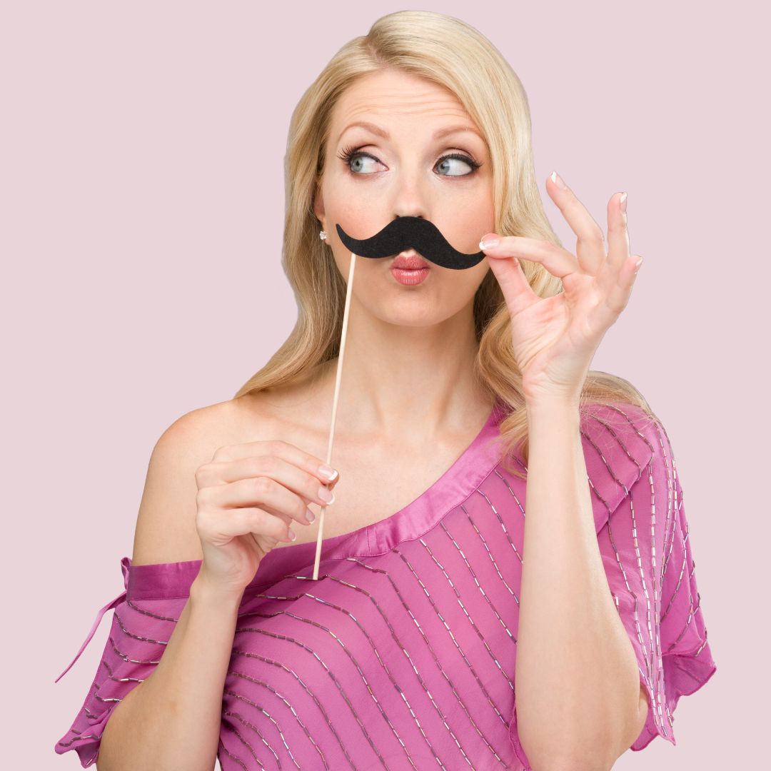 blond lady holding a fake moustache under her nose
