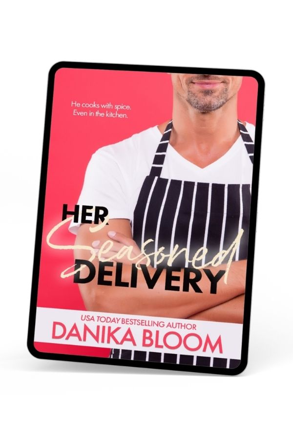 Tablet displaying the cover of Her Seasoned Delivery, a contemporary romance novella by Danika Bloom, showing a man in a striped apron on a bright pink background.